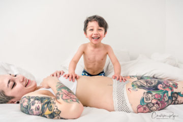 really happy boy playing with his mom in her underwear