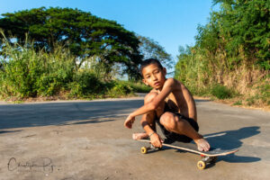 shirtless boy on skateboard