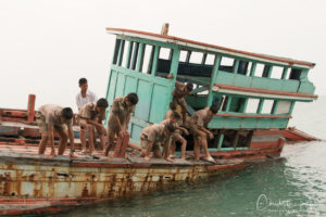 thai boy scouts on an abandoned fishing boat